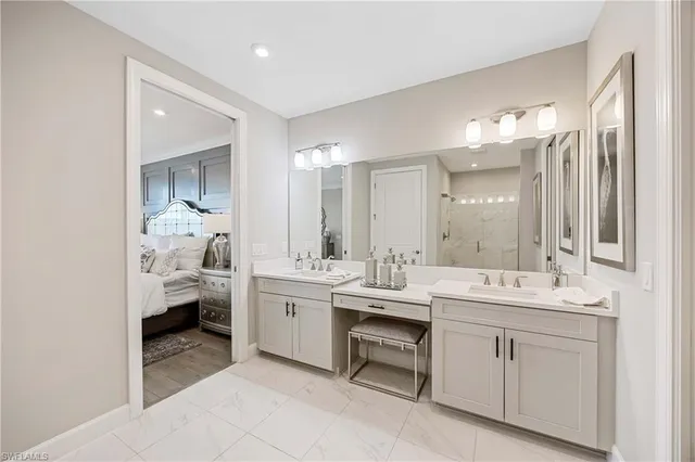 a spacious bathroom with a double vanity sink and mirror
