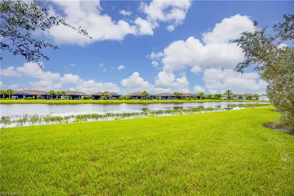 a view of a lake with houses in the back