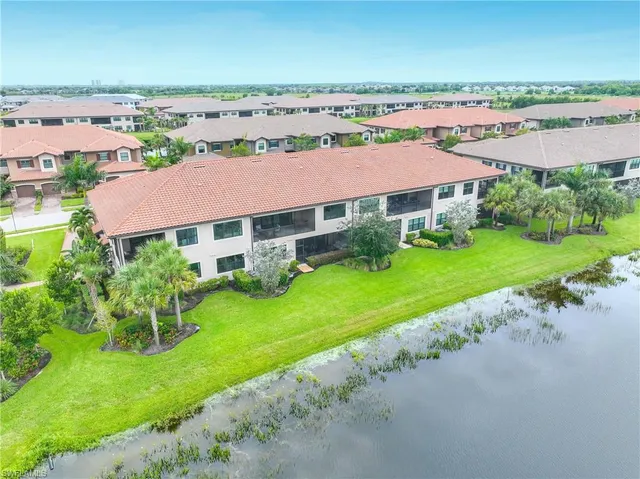 an aerial view of a house with a garden and lake view