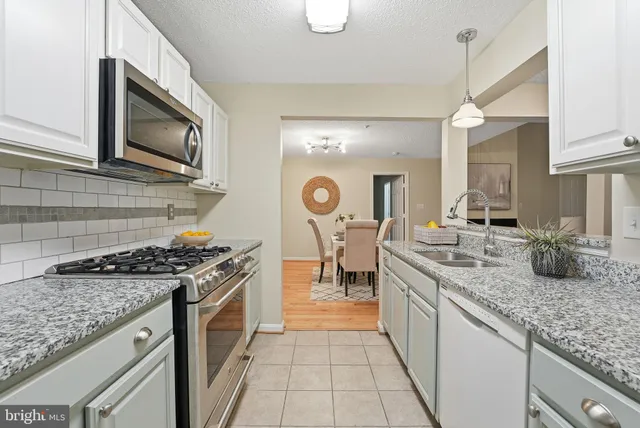 a kitchen with a stove and a sink