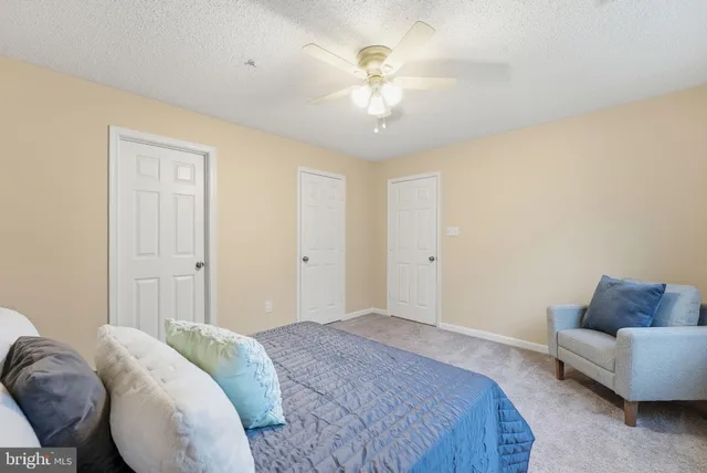 a bedroom with a bed and a couch