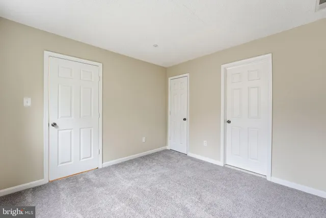 an empty room with closet area