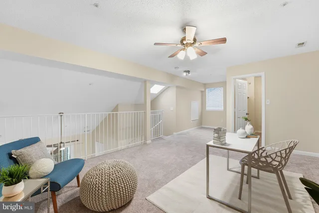 a workspace with wooden floor and a chandelier fan