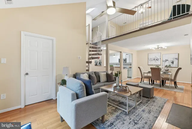 a living room with furniture wooden floor and a chandelier