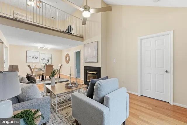 a living room with furniture fireplace and a wooden floor
