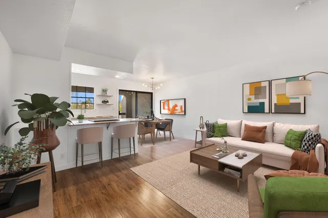 a living room with furniture and wooden floor