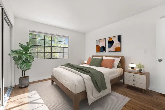 a bedroom with bed and a window