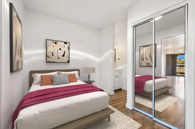 a bedroom with a bed and glass walk in closet