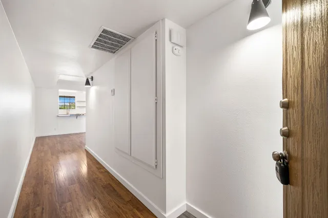 a view of hallway with wooden floor
