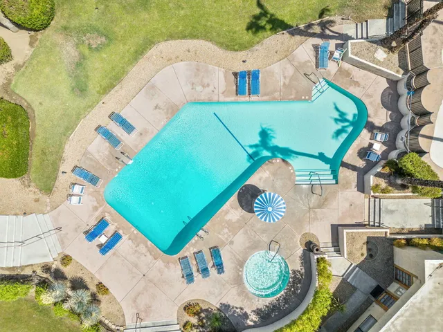 an aerial view of a house with swimming pool
