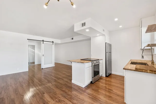a kitchen with granite countertop a stove and a refrigerator