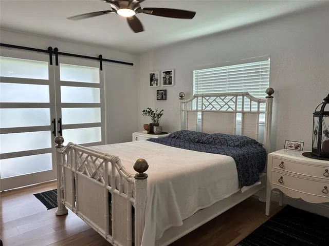 a bedroom with a bed and a large window
