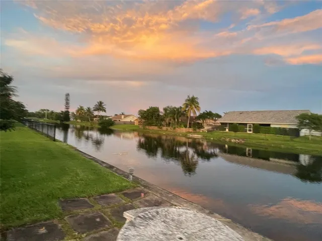 a view of a lake with houses in the back