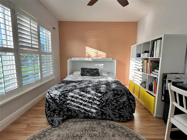a bedroom with a bed and a book shelf