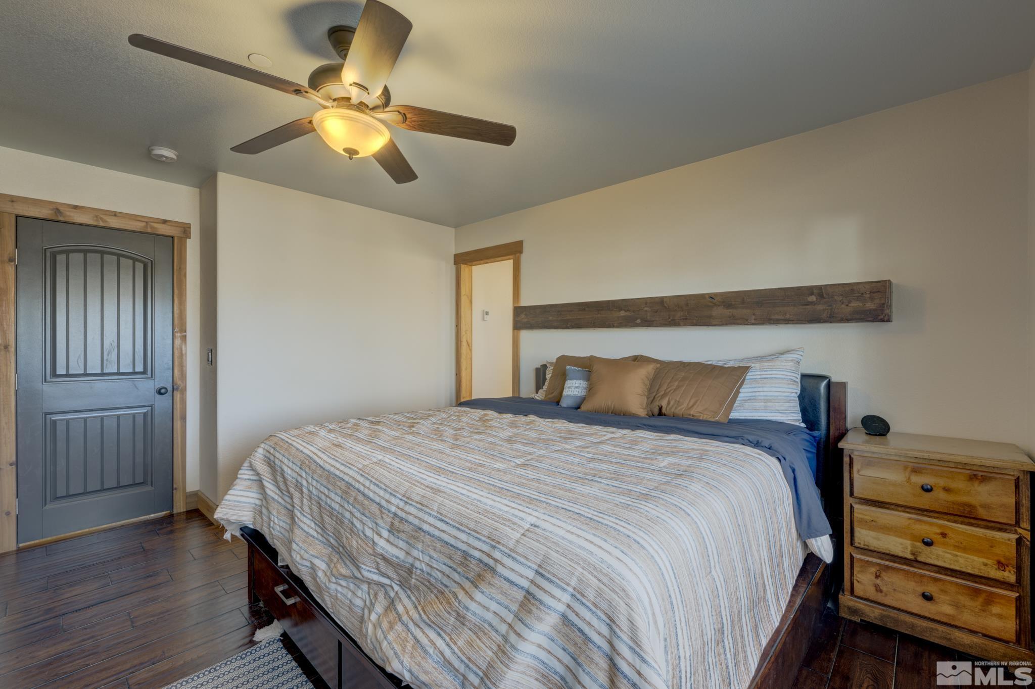 10500 Wells Fargo Road Reno, NV 89508 - Photo 14 of 37 a bedroom with a bed and wooden floor