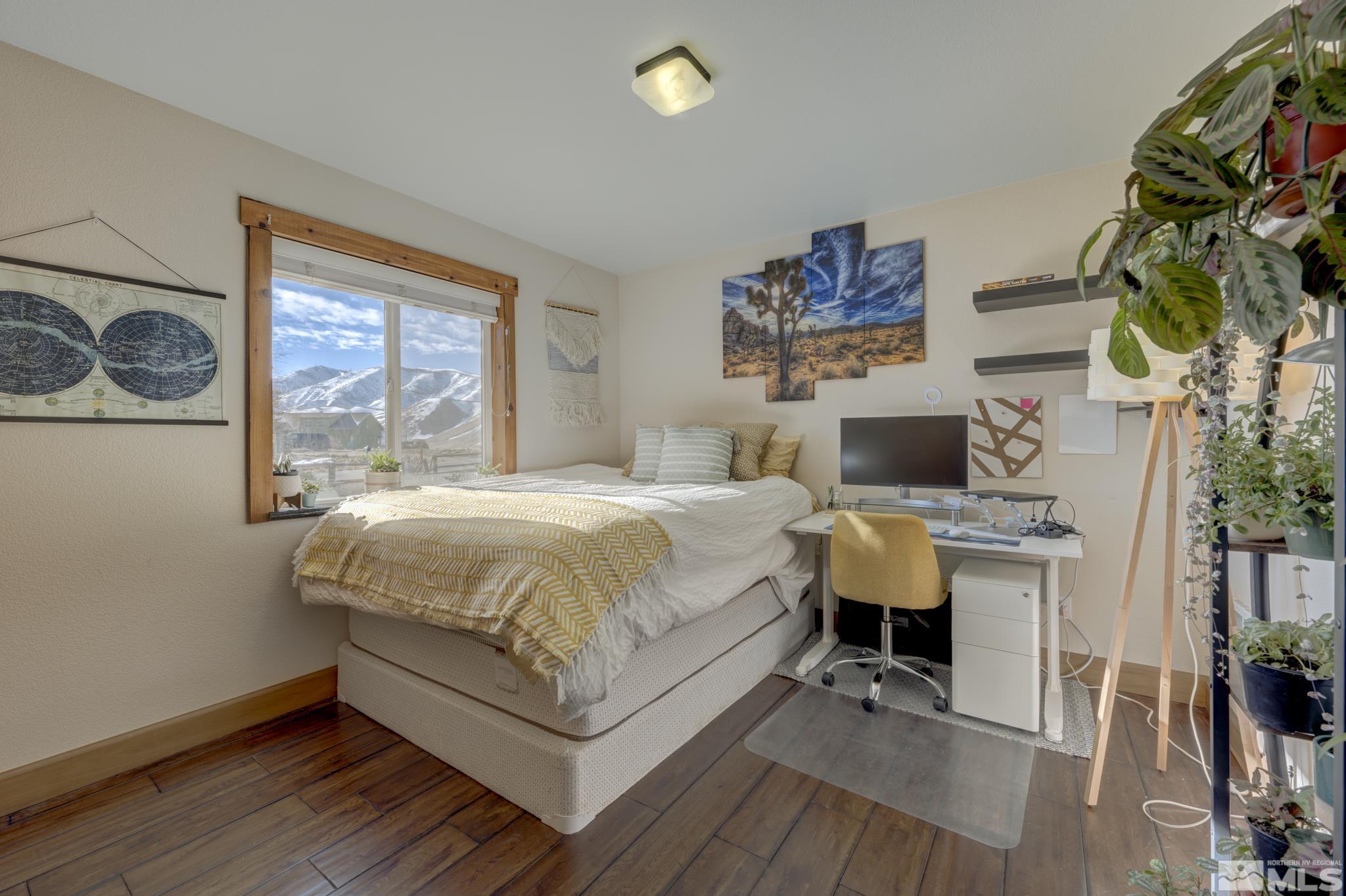 10500 Wells Fargo Road Reno, NV 89508 - Photo 18 of 37 a spacious bedroom with a bed and a table in it