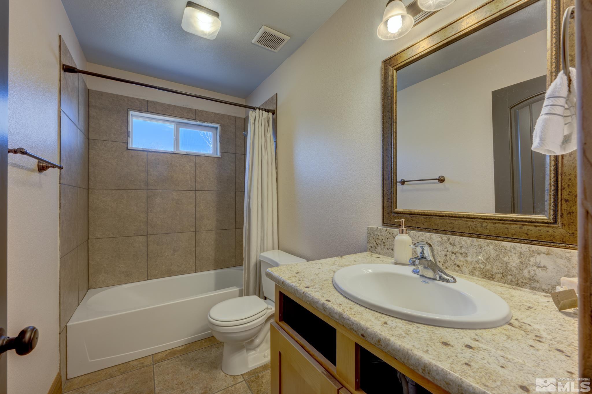 10500 Wells Fargo Road Reno, NV 89508 - Photo 21 of 37 a bathroom with a granite countertop sink toilet and shower