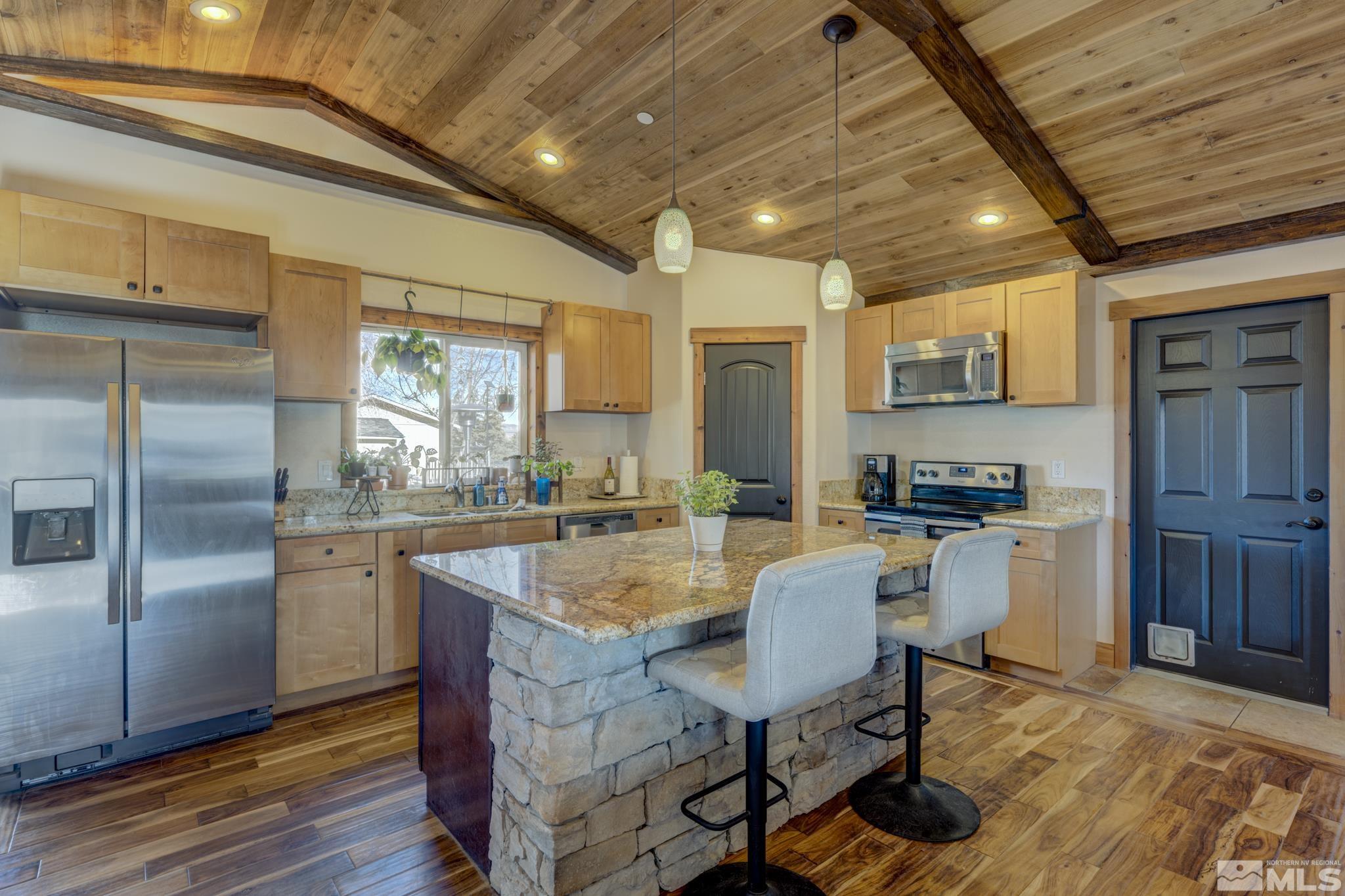 10500 Wells Fargo Road Reno, NV 89508 - Photo 9 of 37 a kitchen with sink cabinets and wooden floor