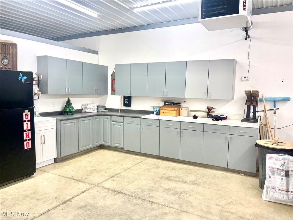 37250 Harry's Ridge Road Barnesville, OH 43713 - Photo 42 of 50 garage/ mancave, Kitchen with gray cabinetry and black refrigerator