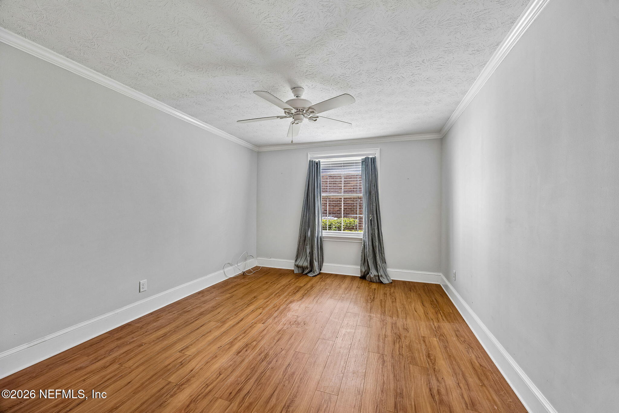 4358 Timuquana Road, Unit 134 Jacksonville, FL 32210 - Photo 9 of 31 an empty room with a hardwood and ceiling fan