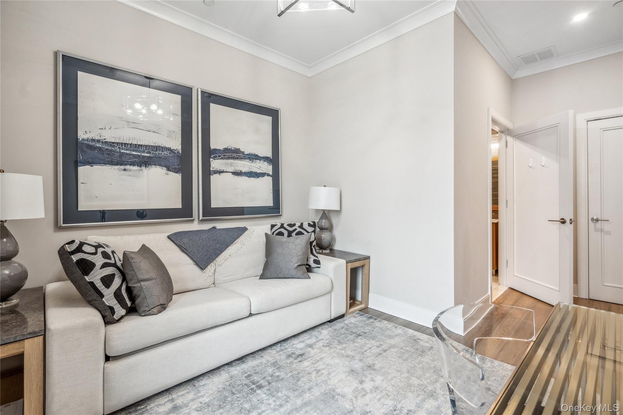 100 Garvies Point Road, Unit 1126 Glen Cove, NY 11542 - Photo 11 of 40 Living room with hardwood / wood-style floors and ornamental molding