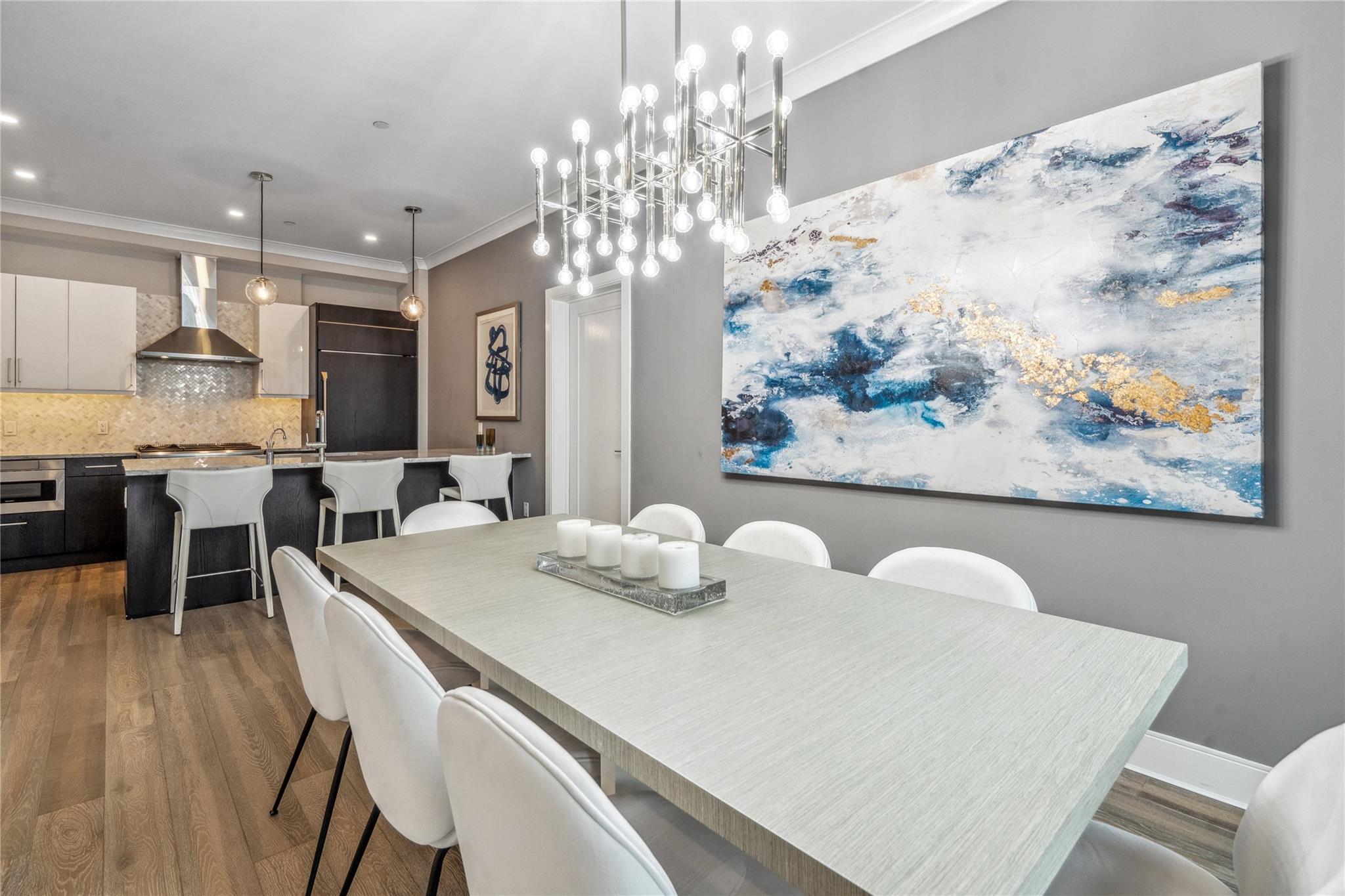 100 Garvies Point Road, Unit 1126 Glen Cove, NY 11542 - Photo 14 of 40 Dining room with a chandelier, crown molding, and dark wood-type flooring