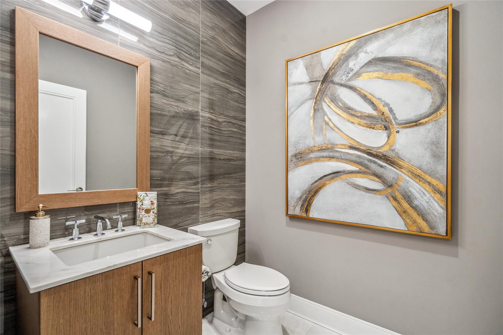100 Garvies Point Road, Unit 1126 Glen Cove, NY 11542 - Photo 16 of 40 Bathroom with backsplash, tile patterned floors, toilet, vanity, and tile walls