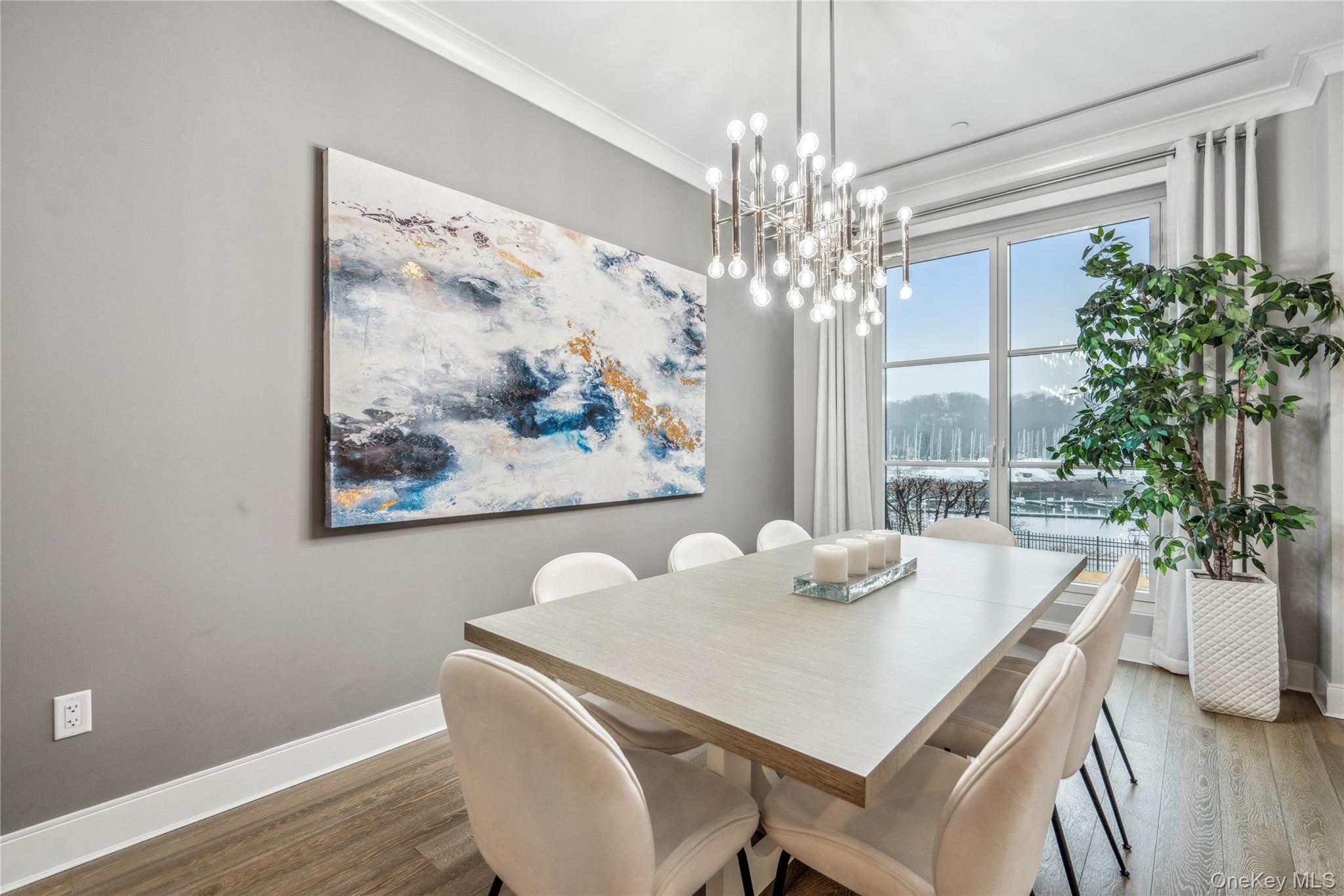 100 Garvies Point Road, Unit 1126 Glen Cove, NY 11542 - Photo 19 of 40 Dining space with dark hardwood / wood-style flooring, crown molding, and an inviting chandelier