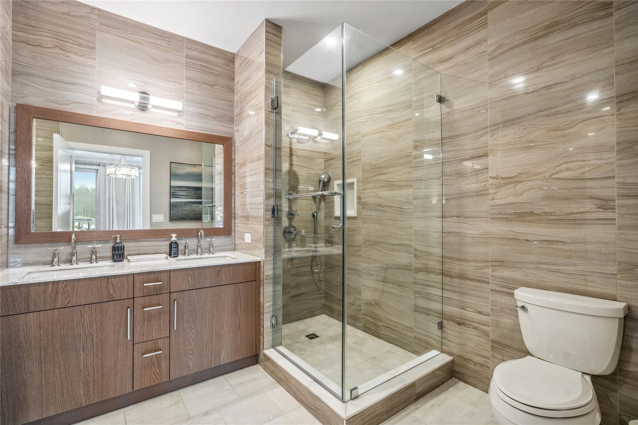 100 Garvies Point Road, Unit 1126 Glen Cove, NY 11542 - Photo 29 of 40 Bathroom with vanity, tile walls, tile patterned flooring, toilet, and a shower with shower door