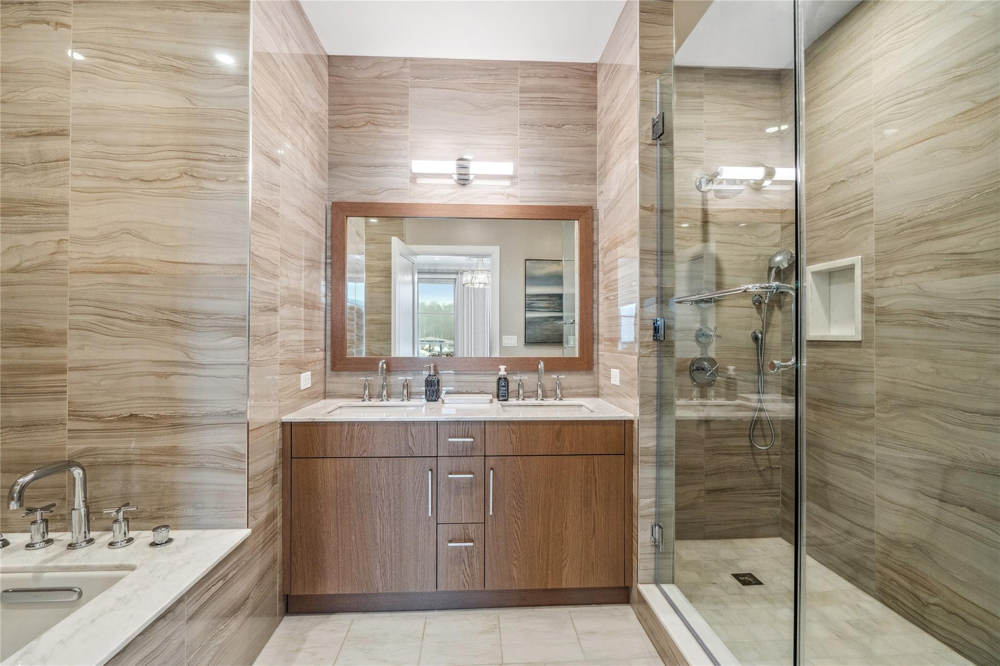 100 Garvies Point Road, Unit 1126 Glen Cove, NY 11542 - Photo 30 of 40 Bathroom with tile patterned flooring, vanity, tile walls, and a shower with shower door