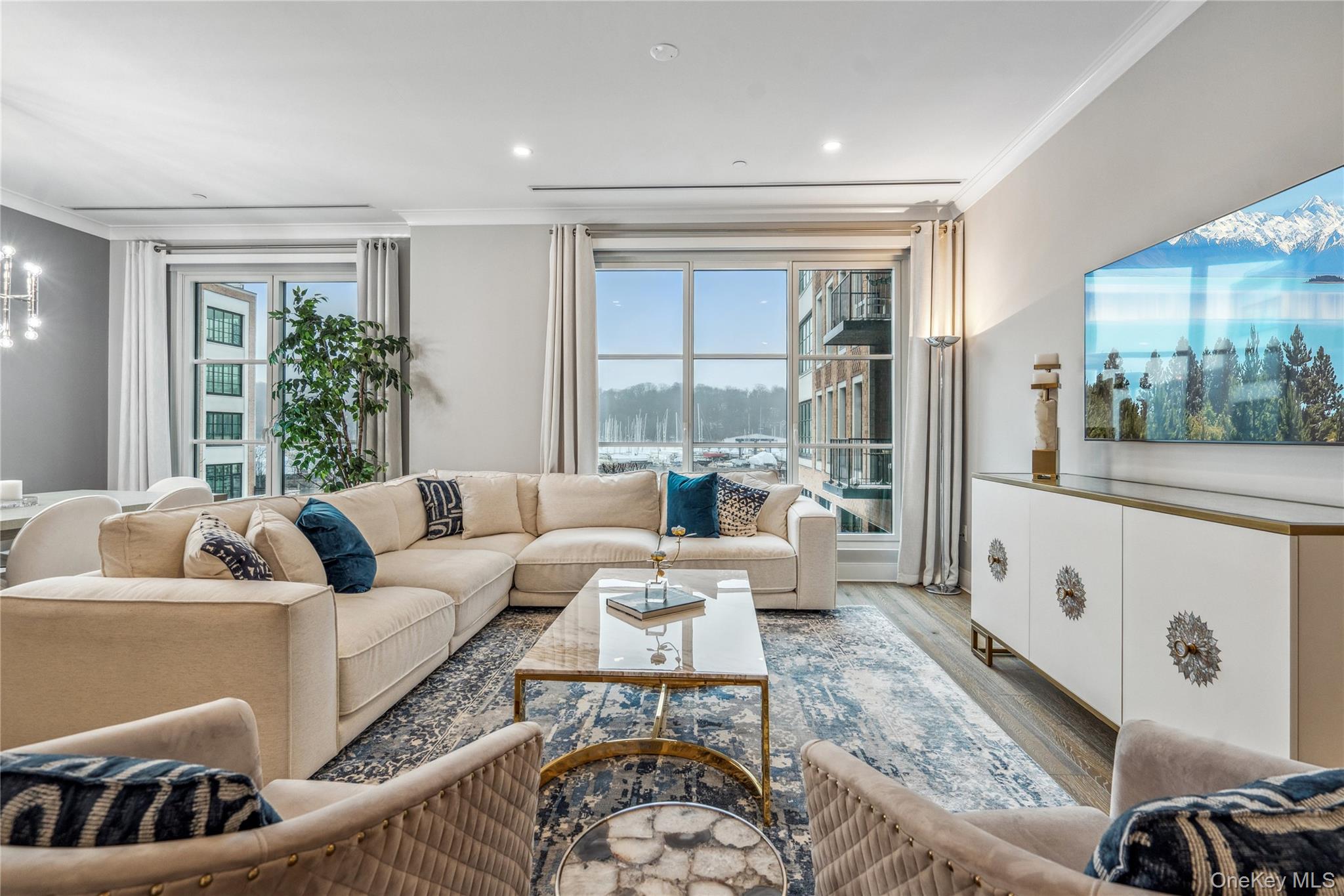 100 Garvies Point Road, Unit 1126 Glen Cove, NY 11542 - Photo 5 of 40 Living room with plenty of natural light, light wood-type flooring, and crown molding