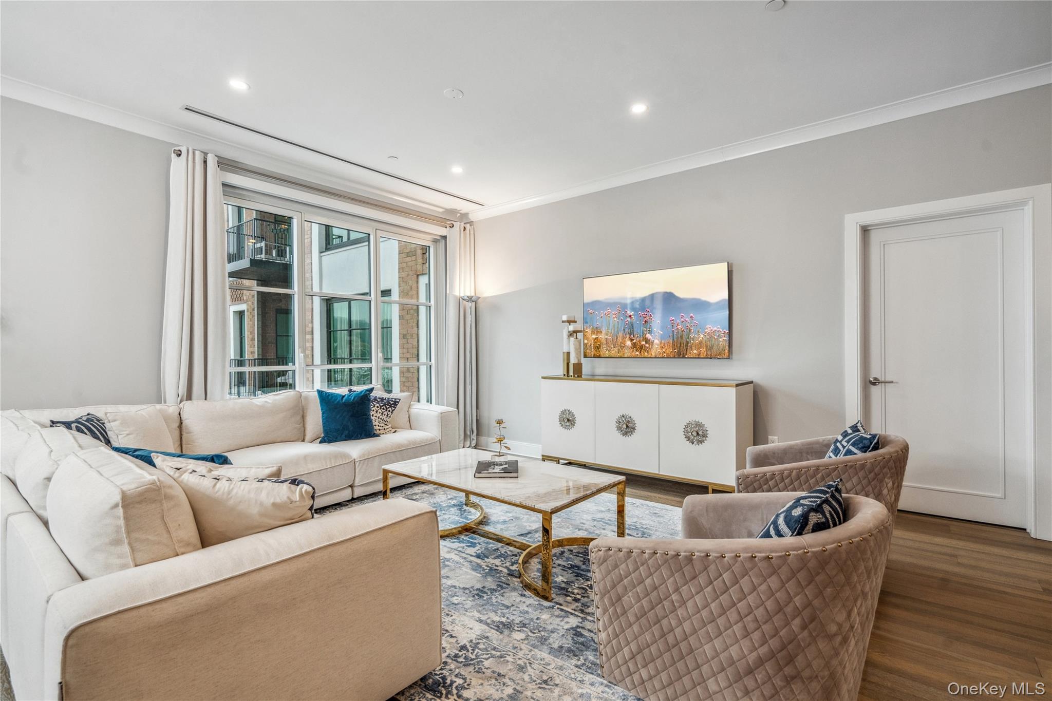 100 Garvies Point Road, Unit 1126 Glen Cove, NY 11542 - Photo 8 of 40 Living room with wood-type flooring and ornamental molding
