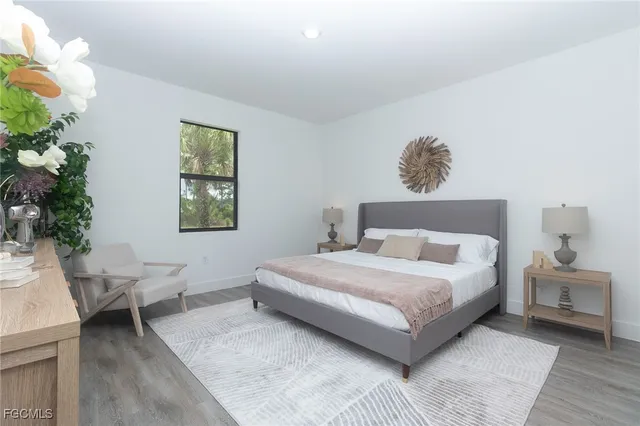 a bedroom with a bed and a potted plant