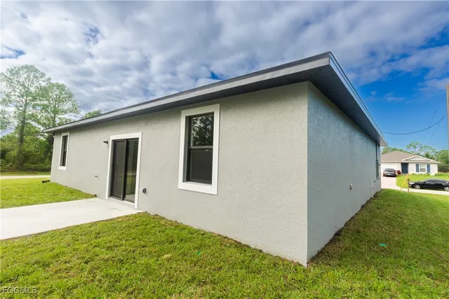 a backyard of a house with large trees