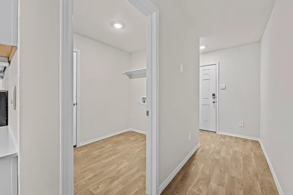 a view of hallway with wooden floor