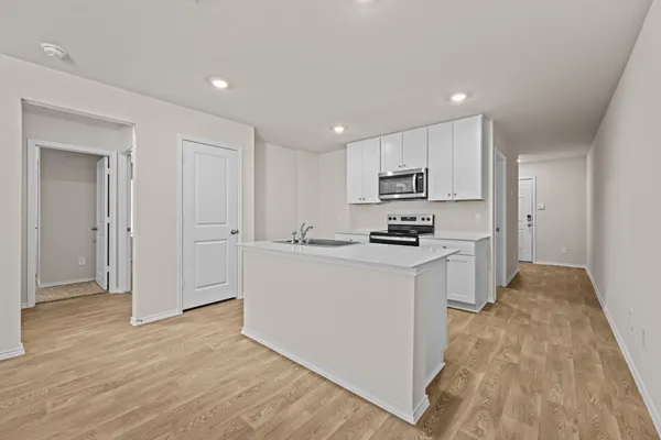 a kitchen with granite countertop white cabinets and stainless steel appliances