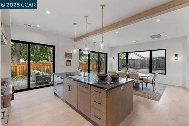 a living room with a granite countertop sink and garden view