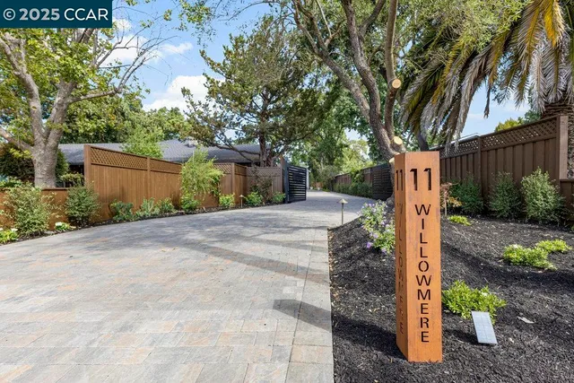 a front view of a house with a yard and tree