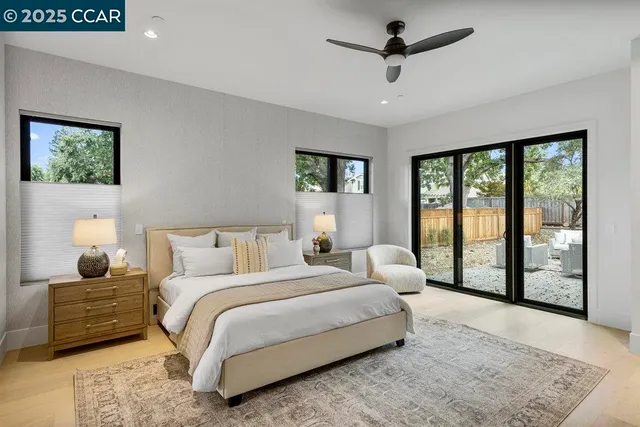 a spacious bathroom with a double vanity sink a mirror and a bathtub