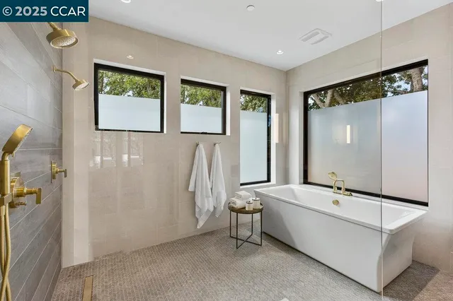 a bathroom with a bathtub and next to a window