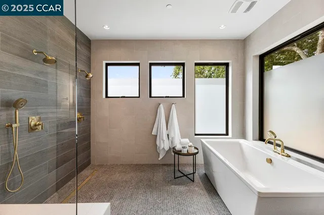 a living room with furniture and a view of kitchen