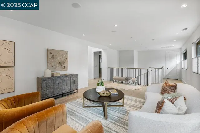 a living room with furniture a rug and a table