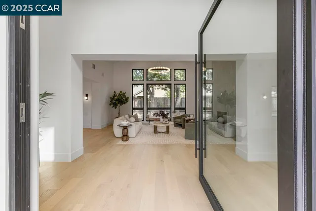 a view of a livingroom with furniture and floor to ceiling window