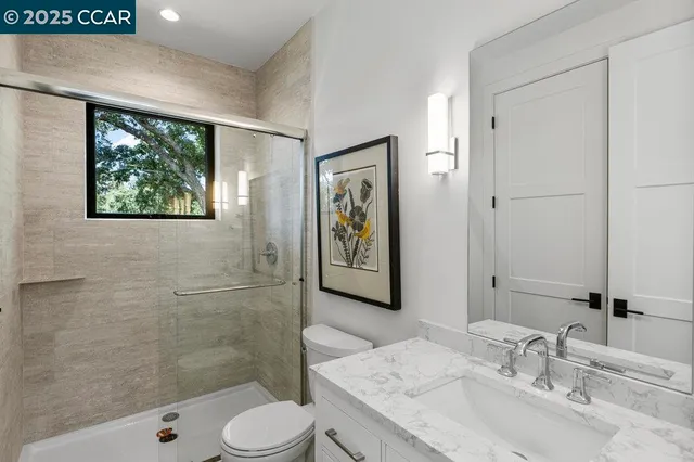 a spacious bedroom with a large mirror and a shower