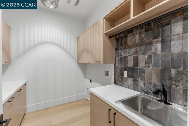 a view of a backyard with pathway of a house