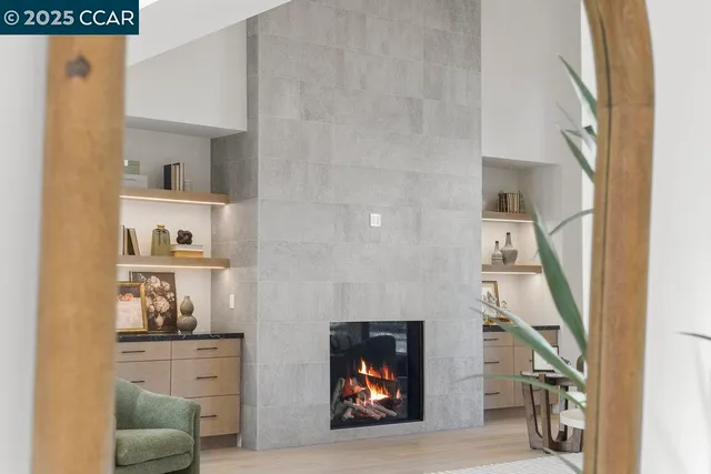 a living room with furniture a table and a large window