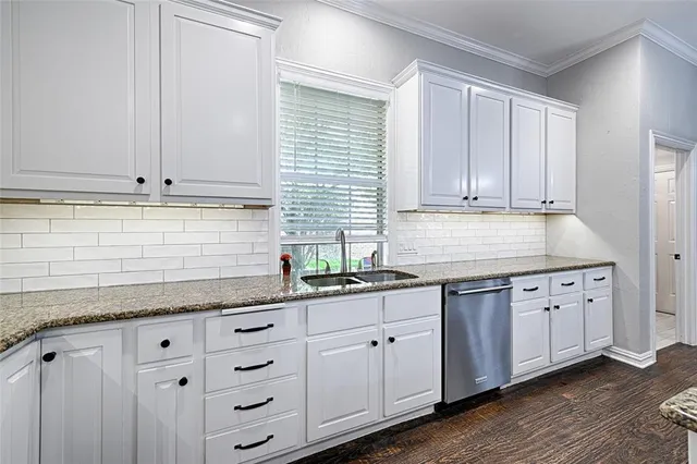 a kitchen with granite countertop white cabinets and white appliances