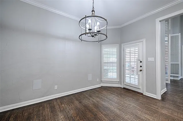 a view of a livingroom with wooden floor and a window