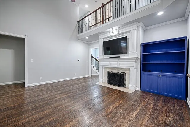a living room with a fireplace and a flat screen tv