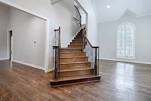 a view of entryway with wooden floor and stairs